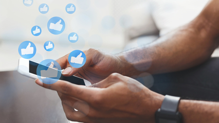 Man using social media app on mobile phone, social network likes