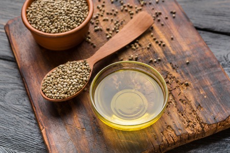Hemp seeds and oil on wooden cutting boardの写真素材