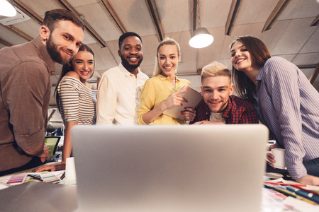 SMM specialists discussing new product marketing promotion in modern coworking spaceの写真素材