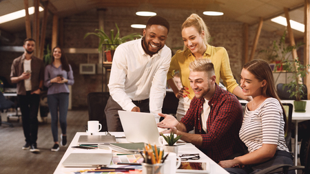 Young colleagues discussing ideas in coworking office, working on new projectの写真素材