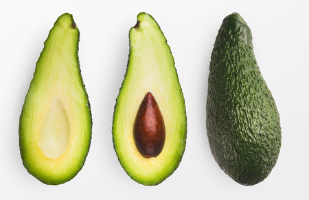 Two halves and whole avocado isolated on white background., top viewの写真素材