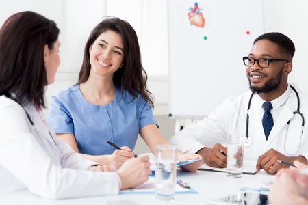 Cardiology conference. Diverse doctors having discussion at meeting in clinicの写真素材