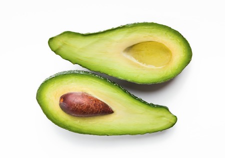 Two halves of ripe avocado with oil on white background, top viewの写真素材