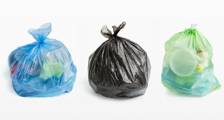 Collage of full plastic garbage bags in row on white background, isolatedの写真素材