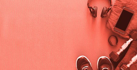 Fitness coral background, male sport equipment for training and outfit, copy space. Weightloss, healthy lifestyle conceptの写真素材
