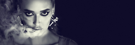 Girl Smoking E-Cigarette. Black and white portrait of woman looking at camera, copy space