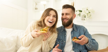 Happy Couple Eating Pizza And Laughing At Home, Having Rest On Weekends, Panoramaの写真素材