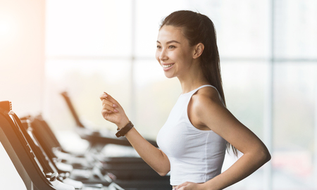 Cardio training. Asian woman running on treadmill, working out in gymの写真素材