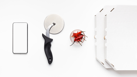 Phone, Cutter, Bowl With Chilli Peppers And Delivery Boxes On White Table, Top Viewの写真素材