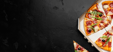 Slices Of Hot Pizza In Delivery Box On Black Background, Panorama, Copy Spaceの写真素材