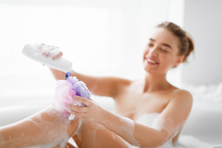 Hygiene Concept. Woman Washing With Sponge, Relaxig In Bath At Homeの写真素材