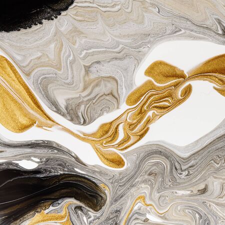 Abstract gold and black stains background, marble texture. Gold mine concept