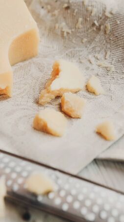 Parmesan cheese piece closeup with small grater, vertical panorama, cropの写真素材