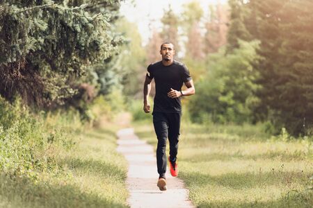 Morning Training. African-American Man Running In Summer Park
