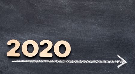2020 concept on time line with arrow on chalk background, panorama, free space