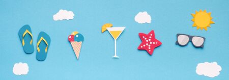 Creative wallpaper with summer accessories in sky, paper photo, panoramaの写真素材