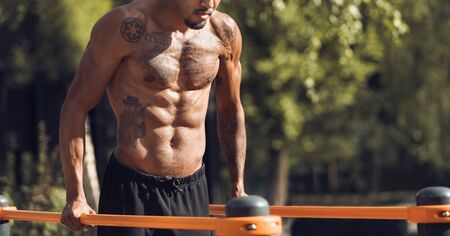 Fit Man Workout Arms On Parallel Bars, Training Triceps, Doing Push Ups Outdoors