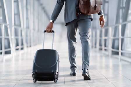 Business Trip. Businessman Carrying Suitcase, Walking Through Passenger Boarding Bridgeの写真素材