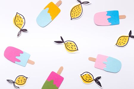 Summer background with eskimo ice cream and fresh lemons on white background, panorama, copy space, paper designの写真素材