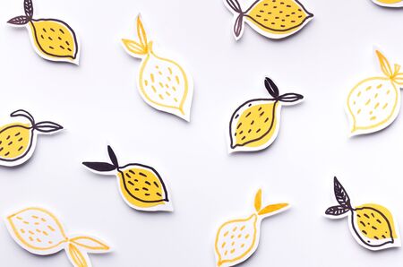 Summer wallpaper of Fresh paper lemons on white background, panorama, copy space, paper gesignの写真素材