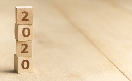 Wooden blocks with 2020 numbers standing on the floor, panorama, copy space