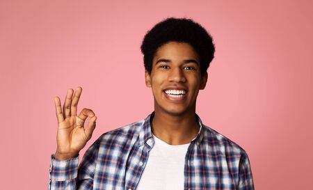Everything is OK. Happy Afro Guy Gesturing OK Sign and Smiling, Pink background