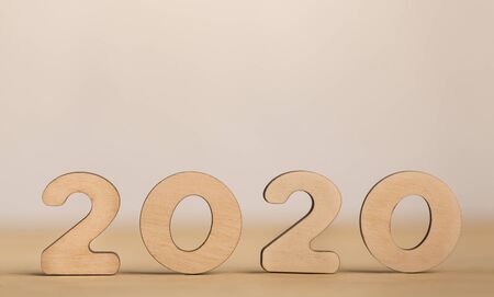 2020 concept. Wooden numbers with round corners on light blurred background, panorama, free spaceの写真素材