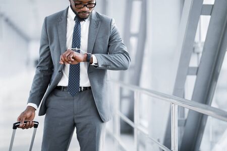 Businessman Checking Time On Watch, Walking In Airport, Crop, Copy Space