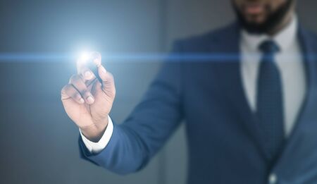 Businessman click on virtual touchscreen. Futuristic business and IT presentation background, free spaceの写真素材