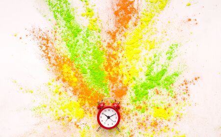 Coloured holi powder explosion out of alarm clock on white background, panoramaの写真素材