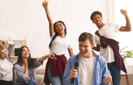 Friends having home party, singing songs, spending time together