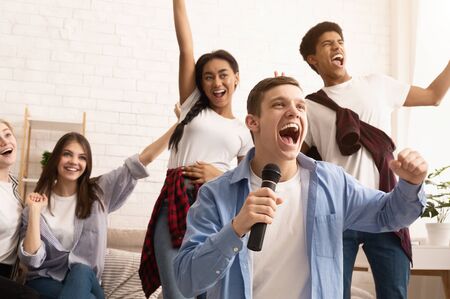 Happy teen friends singing songs, spending time together and having funの写真素材