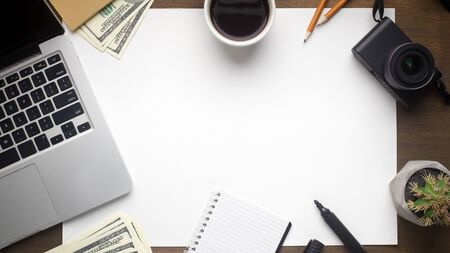 Office table with laptop and blank sheet of paper, panorama, copy spaceの写真素材