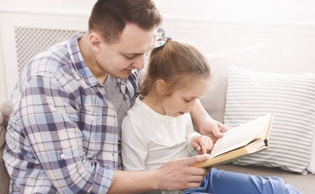 Father And Daughter Are Reading Book, learning reading, empty space, panorama