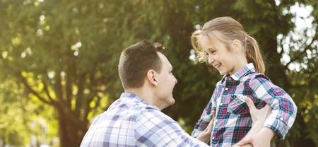 Little Girl Is Waiting To Be Thrown Up In The Air By Her Daddy, having fun in the park, panoramaの写真素材