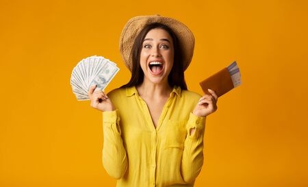 Vacation Time. Woman Holding Money, Passport And Tickets On Yellow Studio Background. Free Space, Panoramaの写真素材