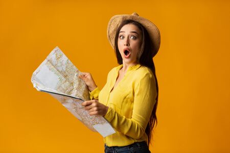 Ready For Adventures. Excited Girl Holding Map On Yellow Background. Summer Vacation Concept....