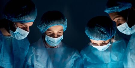 Team of surgeons at work. Doctors performing operation in hospitalの写真素材