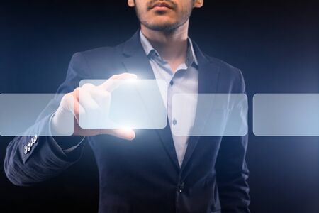 Businessman choosing digital frames with copy space for information on invisible screenの写真素材