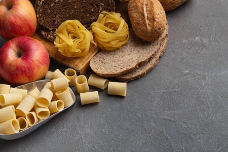 Close up of food with healthy carbohydrates on gray background, copy spaceの写真素材