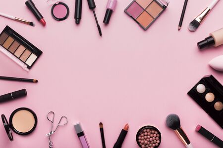 Girlish stuff. Frame of professional cosmetics and brushes around blank space for advertisementの写真素材