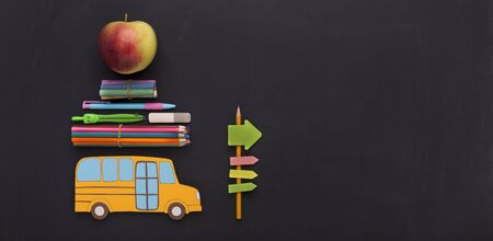 Yellow american school bus with stationery going by road signs to copy space, panoramaの写真素材