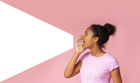 Young girl speaking loud aside to imaginary amplifier holding hand near her open mouth. Side view...
