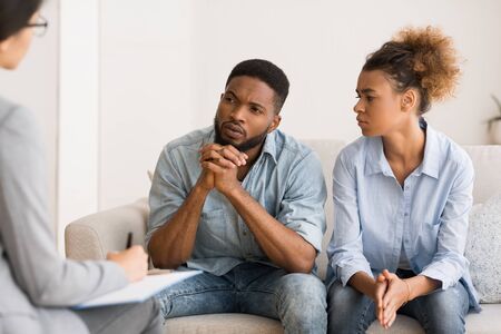 Marital Therapy. Black Couple Listening To Counselors Advice Sitting On Couch In Office.の写真素材