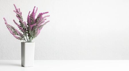 Artificial lavender houseplant over white wall with copy space, panoramaの写真素材