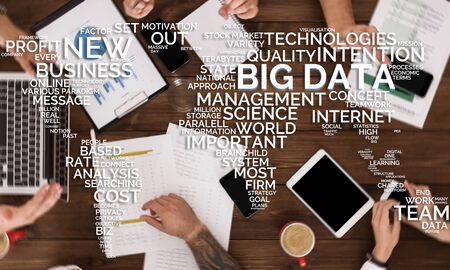 World map concept. Workers discussing Big data storage information on wooden table