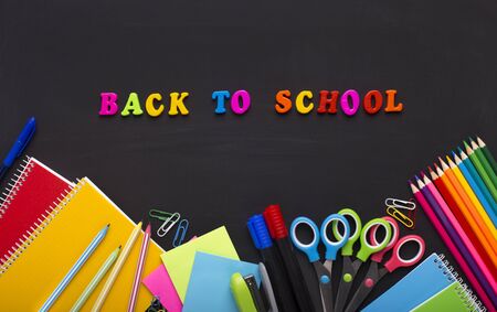 Colored Back to school text with stationery on chalk boardの写真素材