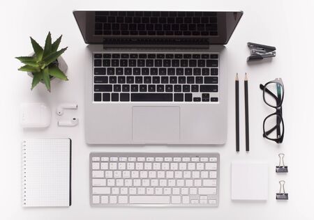 Business concept. Top view of white office desk with laptop and other supplies