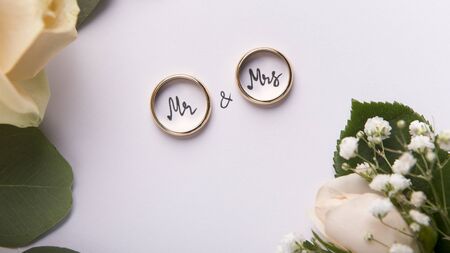 Creative Wedding rings mr and mrs on white background with roses, panoramaの写真素材