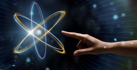Human and science. Female hand reaching to glowing atom projection, panorama